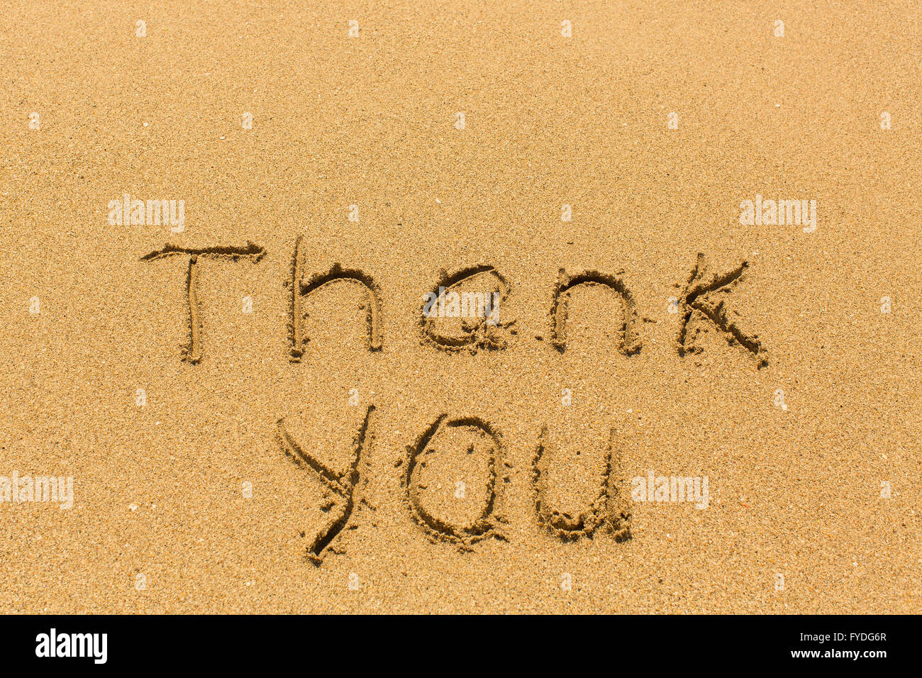Thank you - inscription by hand on golden beach sand Stock Photo - Alamy
