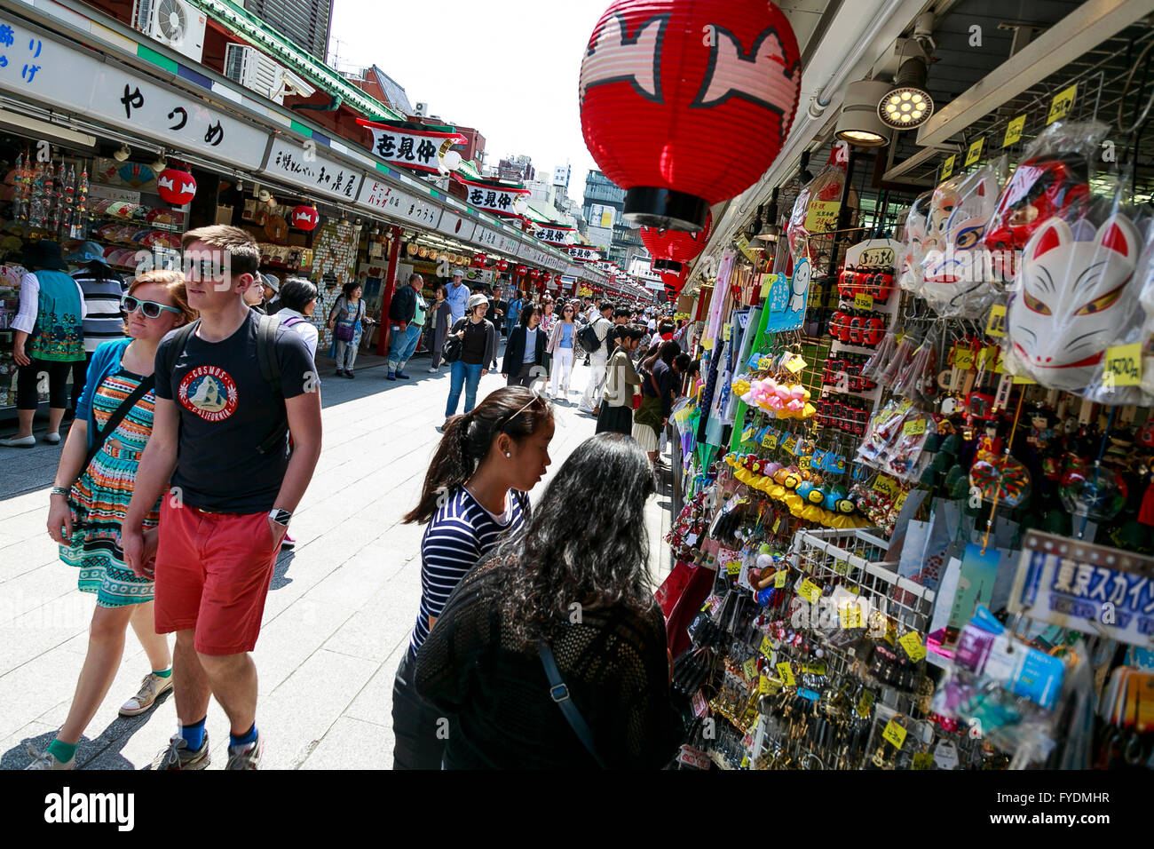 Foreign tourists walk past the souvenir shops in Asakusa district on ...