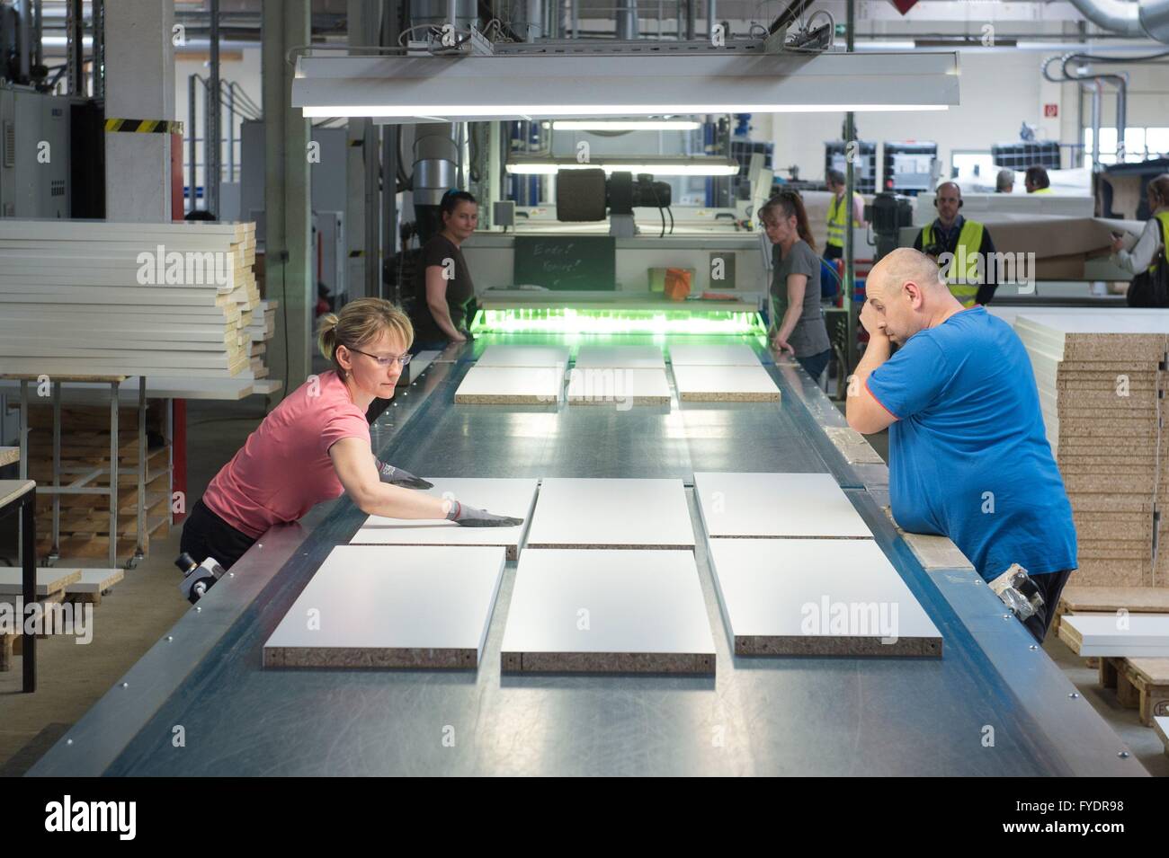 De Alpen Marxistisch Faeröer Production workers examine the painted surface of wooden plates of the Maja  Moebelwerk in Wittichenau (Saxony), Germany, 20 April 2016. The furniture  manufacturing company 'Maja' makes lightweight furnitures for Ikea. Photo:  Sebastian