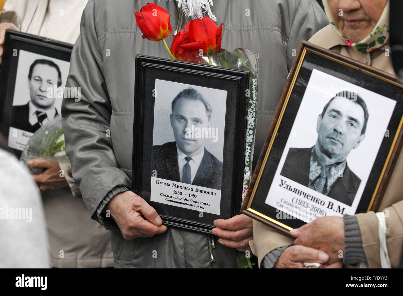 Kiev, Ukraine. 26th Apr, 2016. Ukrainian woman holds portraits of lost relatives, victims of the Chernobyl nuclear disaster, near the Chernobyl victims memorial complex. Ukrainian mark the 30th anniversary of Chernobyl's tragedy, the biggest accident in the history of nuclear power generation, that killed thousands. Credit:  Vasyl Shevchenko/Pacific Press/Alamy Live News Stock Photo