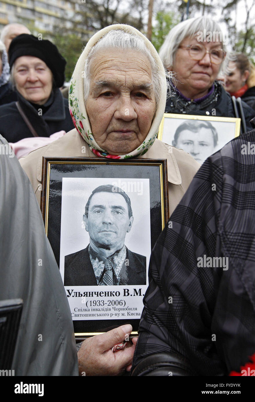 Kiev, Ukraine. 26th Apr, 2016. Ukrainian women hold portraits of lost relatives, victims of the Chernobyl nuclear disaster, near the Chernobyl victims memorial complex. Ukrainian mark the 30th anniversary of Chernobyl's tragedy, the biggest accident in the history of nuclear power generation, that killed thousands. Credit:  Vasyl Shevchenko/Pacific Press/Alamy Live News Stock Photo