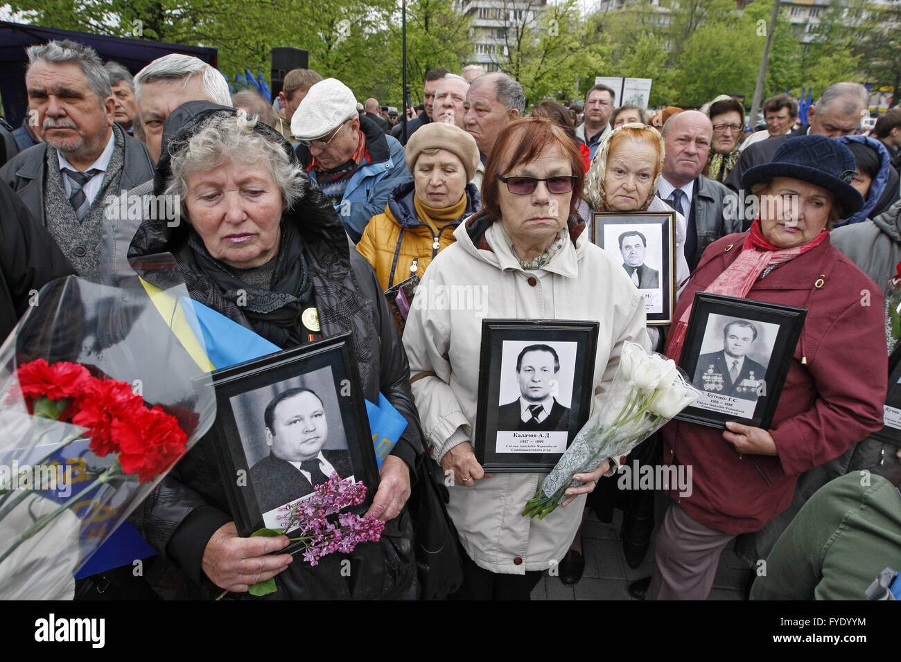 Kiev, Ukraine. 26th Apr, 2016. Ukrainian women holds portraits of lost relatives, victims of the Chernobyl nuclear disaster, near the Chernobyl victims memorial complex . Ukrainian mark the 30th anniversary of Chernobyl's tragedy, the biggest accident in the history of nuclear power generation, that killed thousands. Credit:  Vasyl Shevchenko/Pacific Press/Alamy Live News Stock Photo