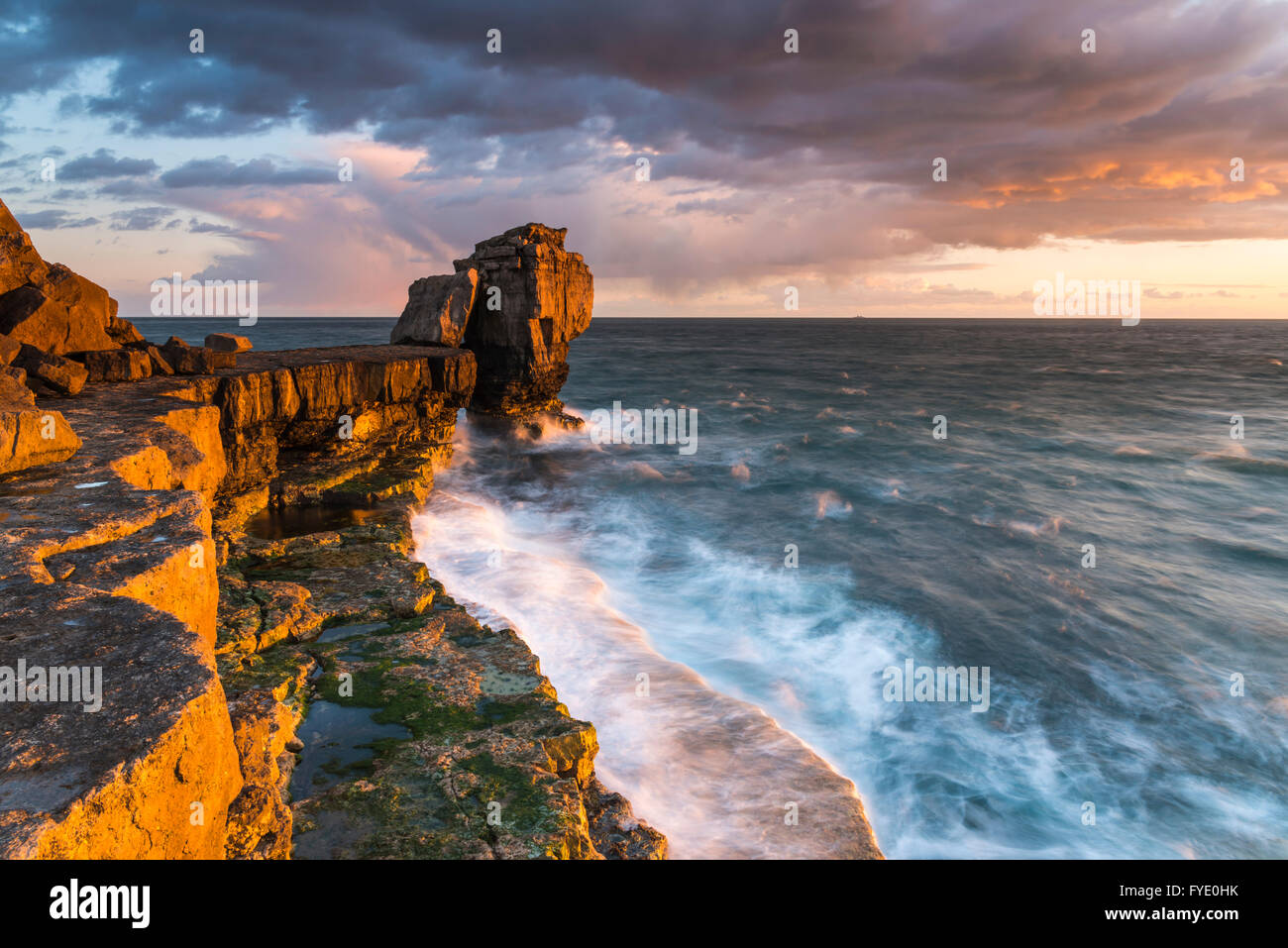 Portland Bill, Dorset, UK. 26th April 2016.  UK Weather - Stormy looking clouds  above Pulpit Rock at Portland Bill on the Jurassic Coast of Dorset shortly before sunset - Picture: Graham Hunt /Alamy Live News Stock Photo