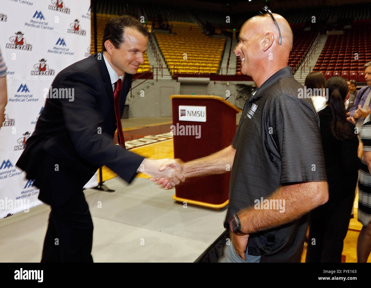 Las Cruces, NM, USA. 26th Apr, 2016. Paul Weir, left, new men's basketball coach at New Mexico State University, is congratulated by football head coach Doug Martin after the official announcement of his appointment at the Pan American Center in Las Cruces, Tuesday, April 26, 2016. Weir, the nine-year assistant for the Aggies who spent the past five seasons as the associate head coach, replaces Marvin Menzies, who last week accepted the head coaching position at UNLV. © Andres Leighton/Albuquerque Journal/ZUMA Wire/Alamy Live News Stock Photo