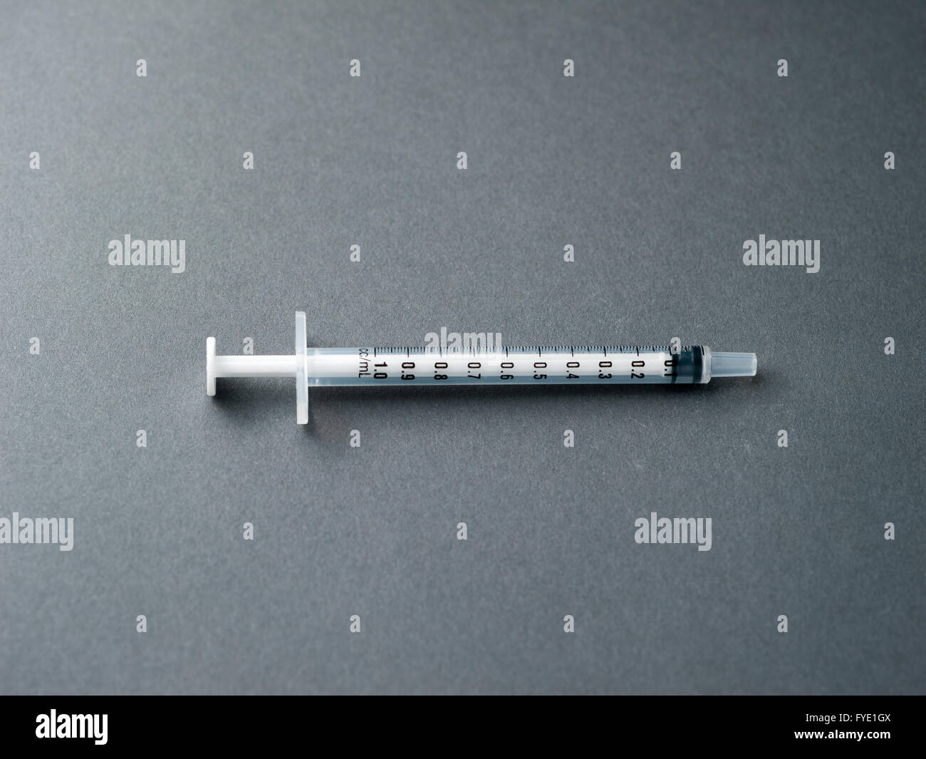 Syringe without a needle on a grey background. Stock Photo