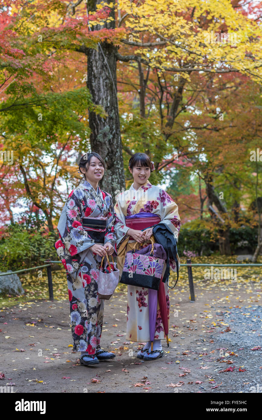 KYOTO, JAPAN - November, 18, 2014: Two japanese girls in traditional kimono, momiji season in Kyoto Stock Photo