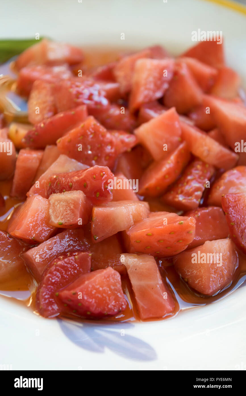 chopped strawberries in a dish seasoned with a vinaigrette Stock Photo