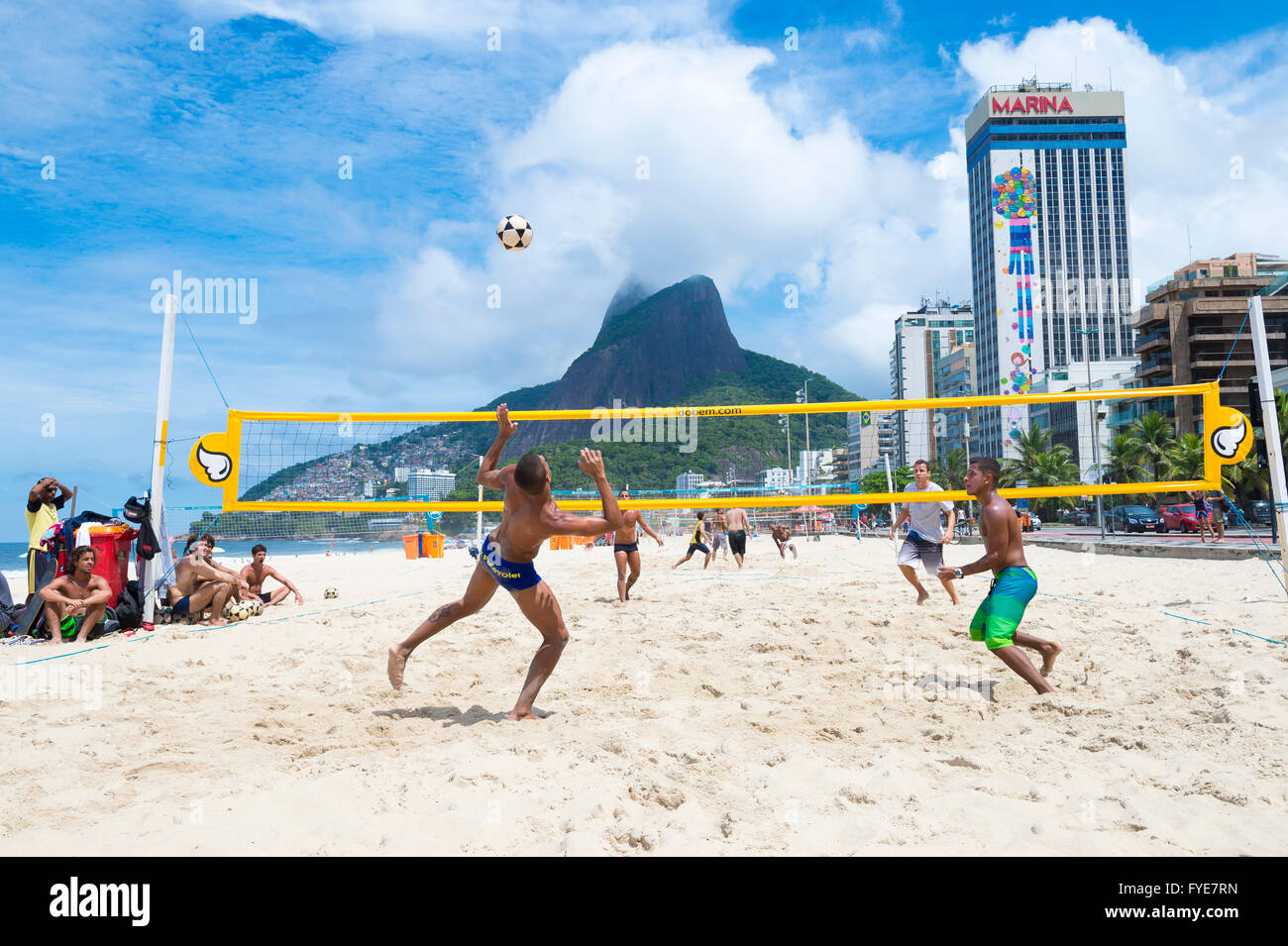 RIO DE JANEIRO - MARCH 17, 2016: Brazilians play a game of futevolei (footvolley), a sport that combines football and volleyball Stock Photo