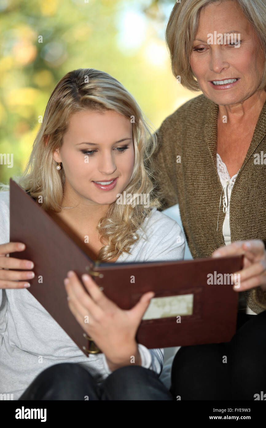 Christmas, photo album or kids with a senior woman and children