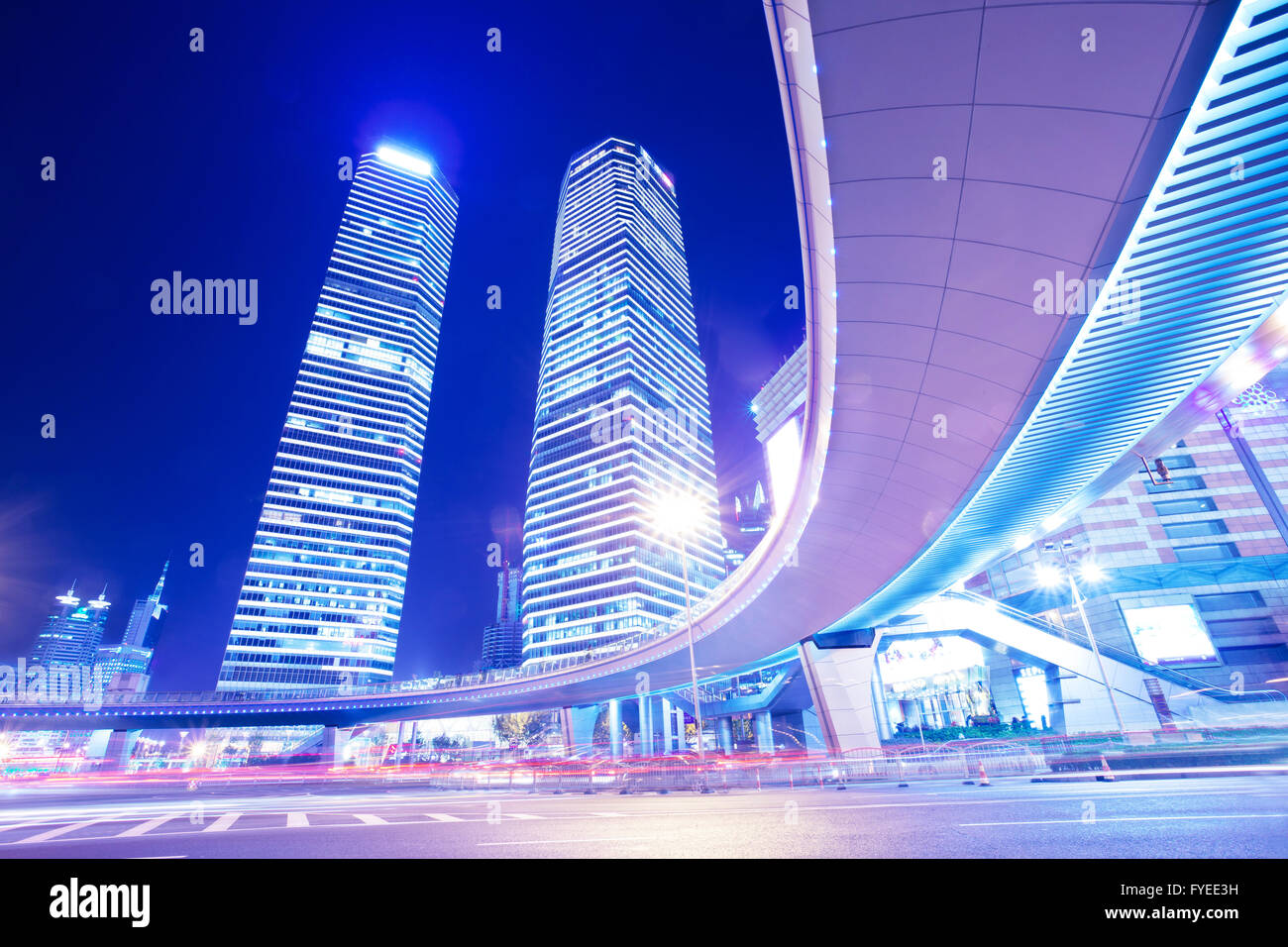 the light trails on the modern building background Stock Photo - Alamy