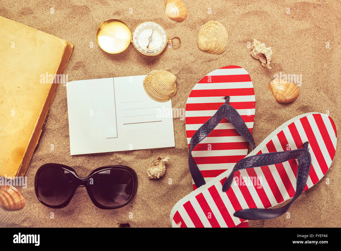 Beach ready, summer holiday vacation accessories on sandy beach, summertime lifestyle objects in flat lay top view arrangement. Stock Photo