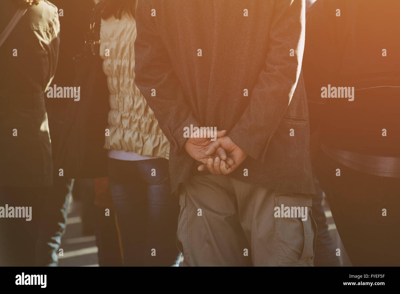 Unrecognizable people on the street during political meeting, audience from behind, selective focus and retro toned image with l Stock Photo