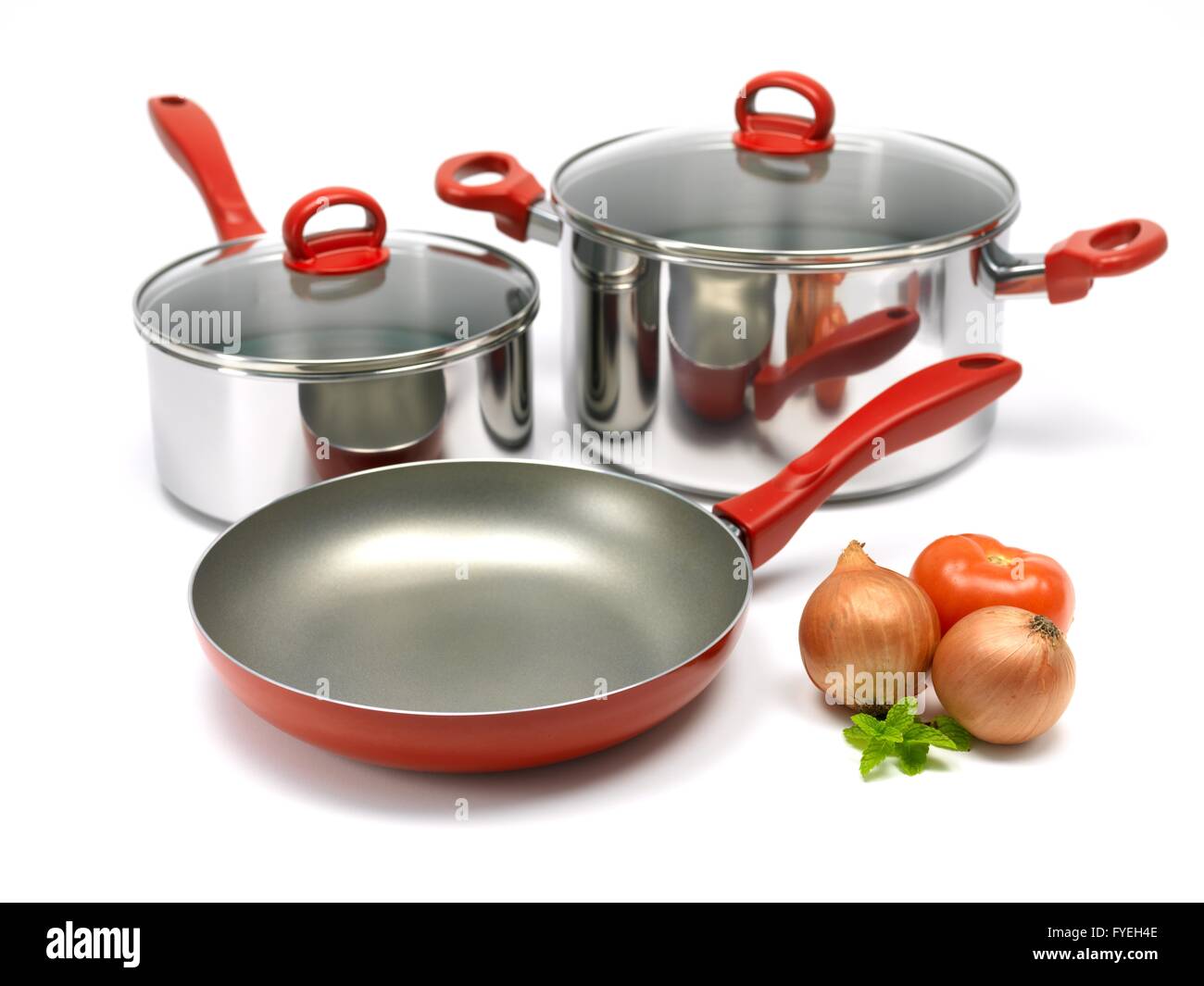 A set of saucepans and a frying pan isolated against a white background