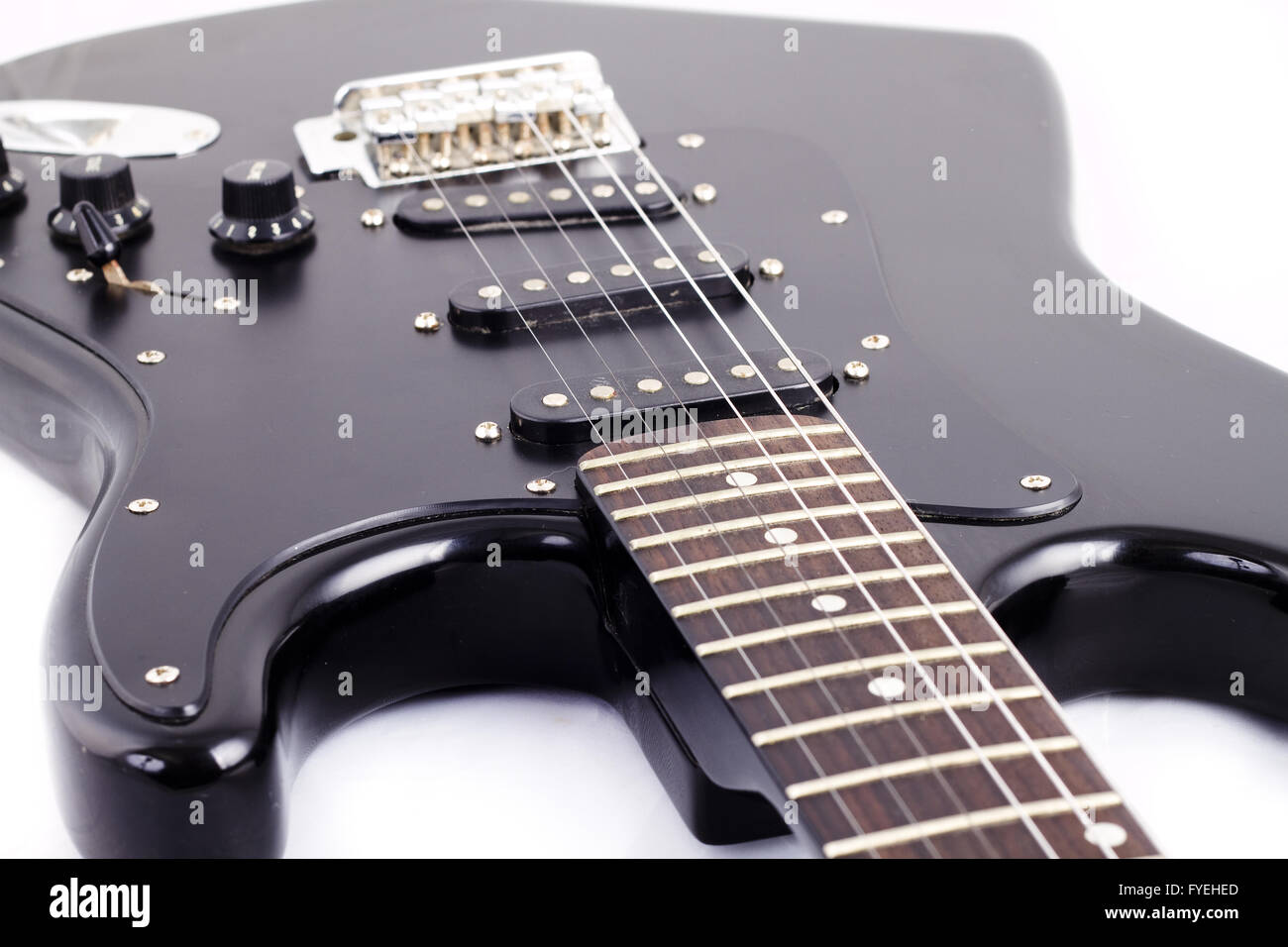 Black electric guitar on white background Stock Photo - Alamy