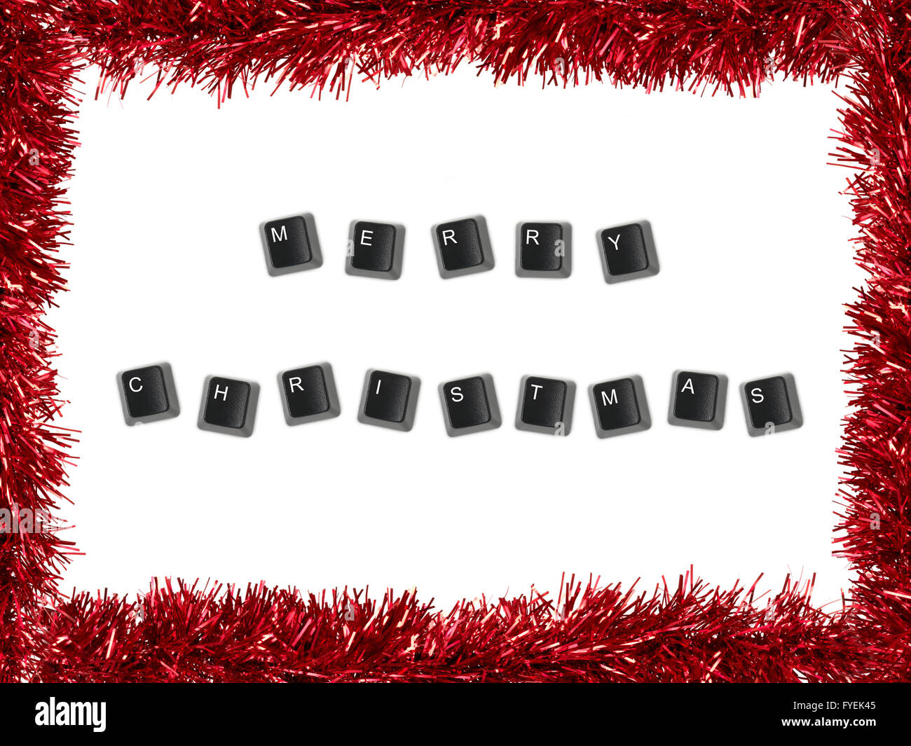 Christmas Tinsel bordering keyboard keys spelling merry christmas Stock