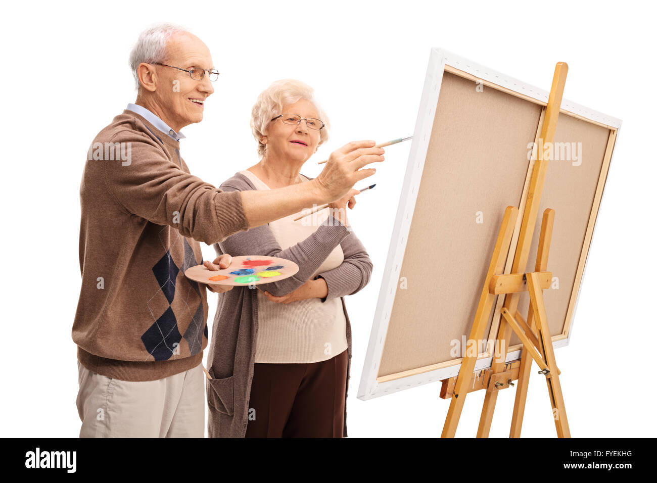 Elderly Couple Painting On A Canvas Together With Paintbrushes Isolated On White Background Stock Photo Alamy
