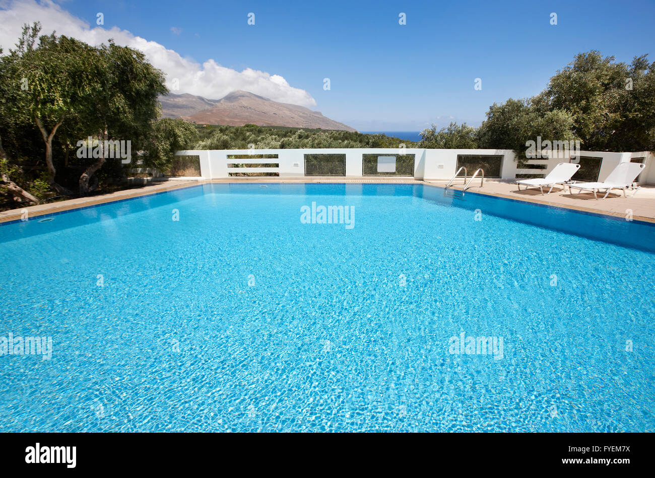 Swimming pool with sunbeds and landscape. Horizontal Stock Photo - Alamy