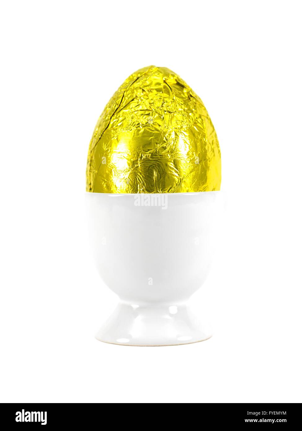 A chocolate Easter egg in a egg cup isolated against a white background Stock Photo