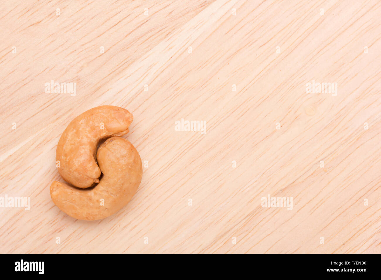two cashew nuts on wood background with copy space Stock Photo