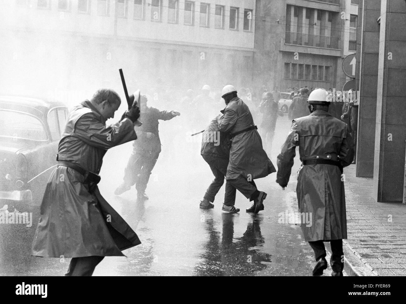 Police uses waterguns against student demonstrators, who protest against the awarding of the Peace Prize of the German Book Trade to Sengalese state president Senghor in front of Paulskirche in Frankfurt on 22 September 1968. Stock Photo