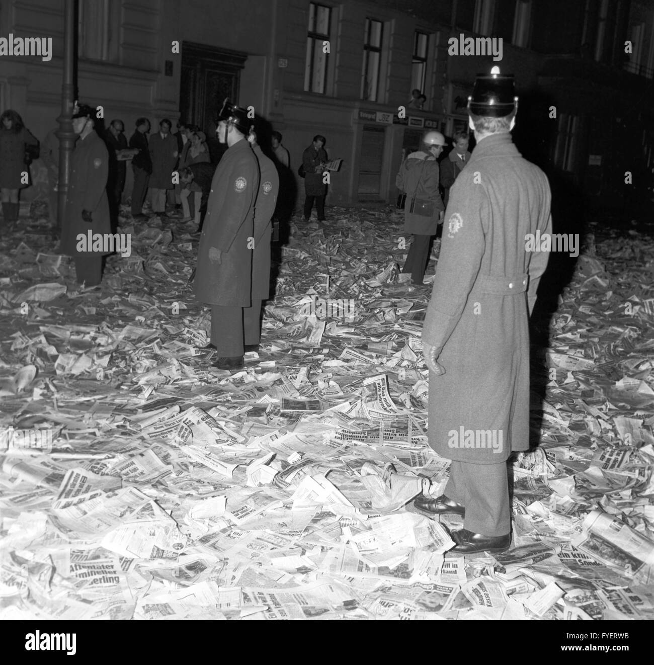 Police on 13 April 1968 in the middle of newspapers by Springer Media Group lying on the ground after protesters had cleared a delivery van to protest the assasination attempt on student spokesperson Rudi Dutschke. Stock Photo