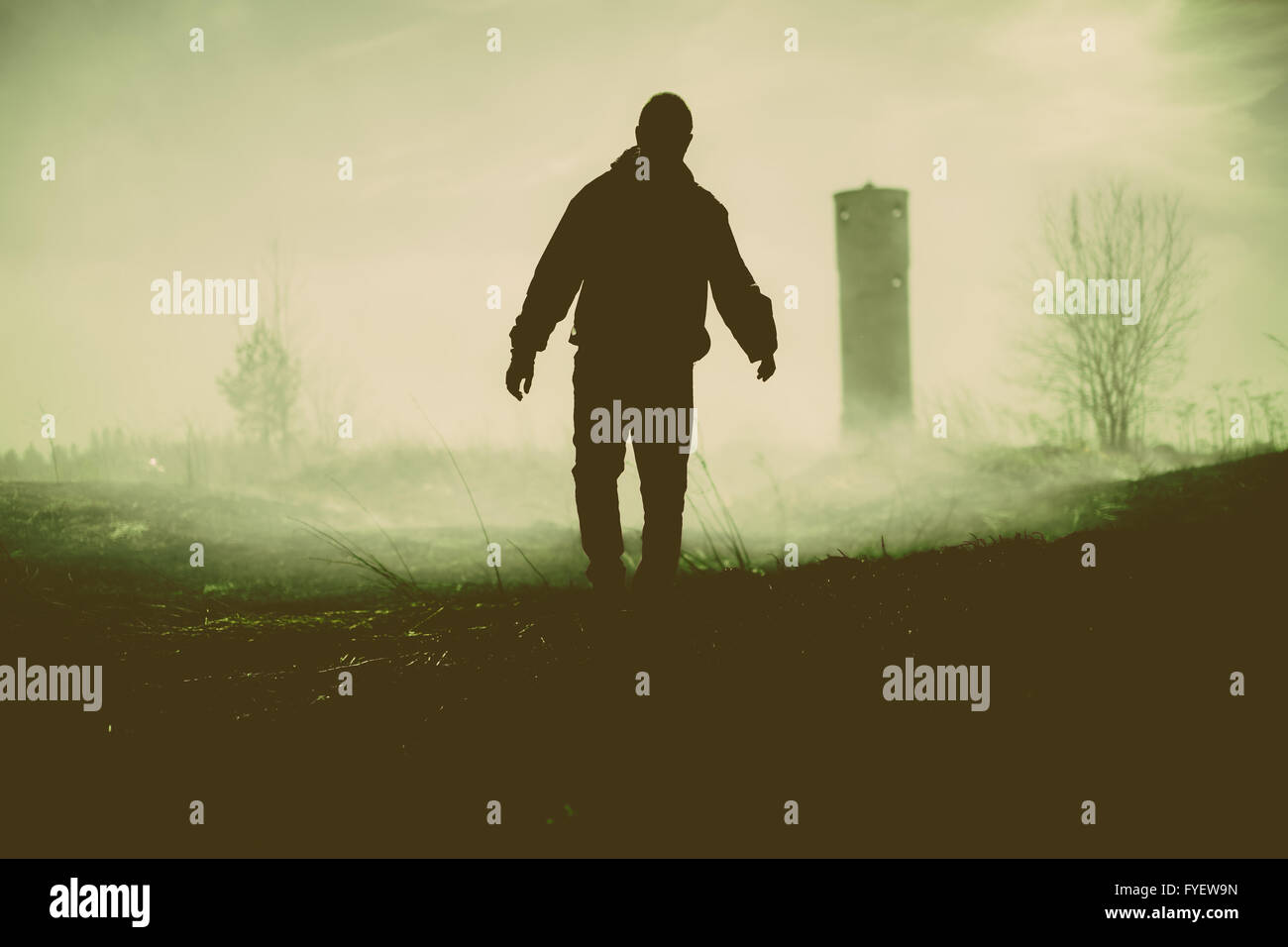 Silhouette of the walking person and tower. Stock Photo