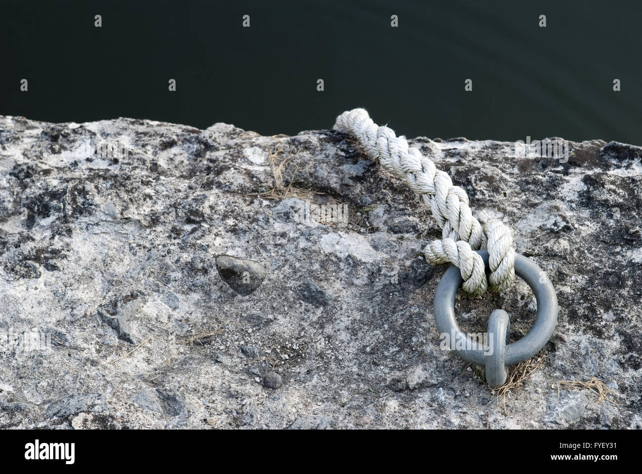 Rope secured to metal ring Stock Photo - Alamy