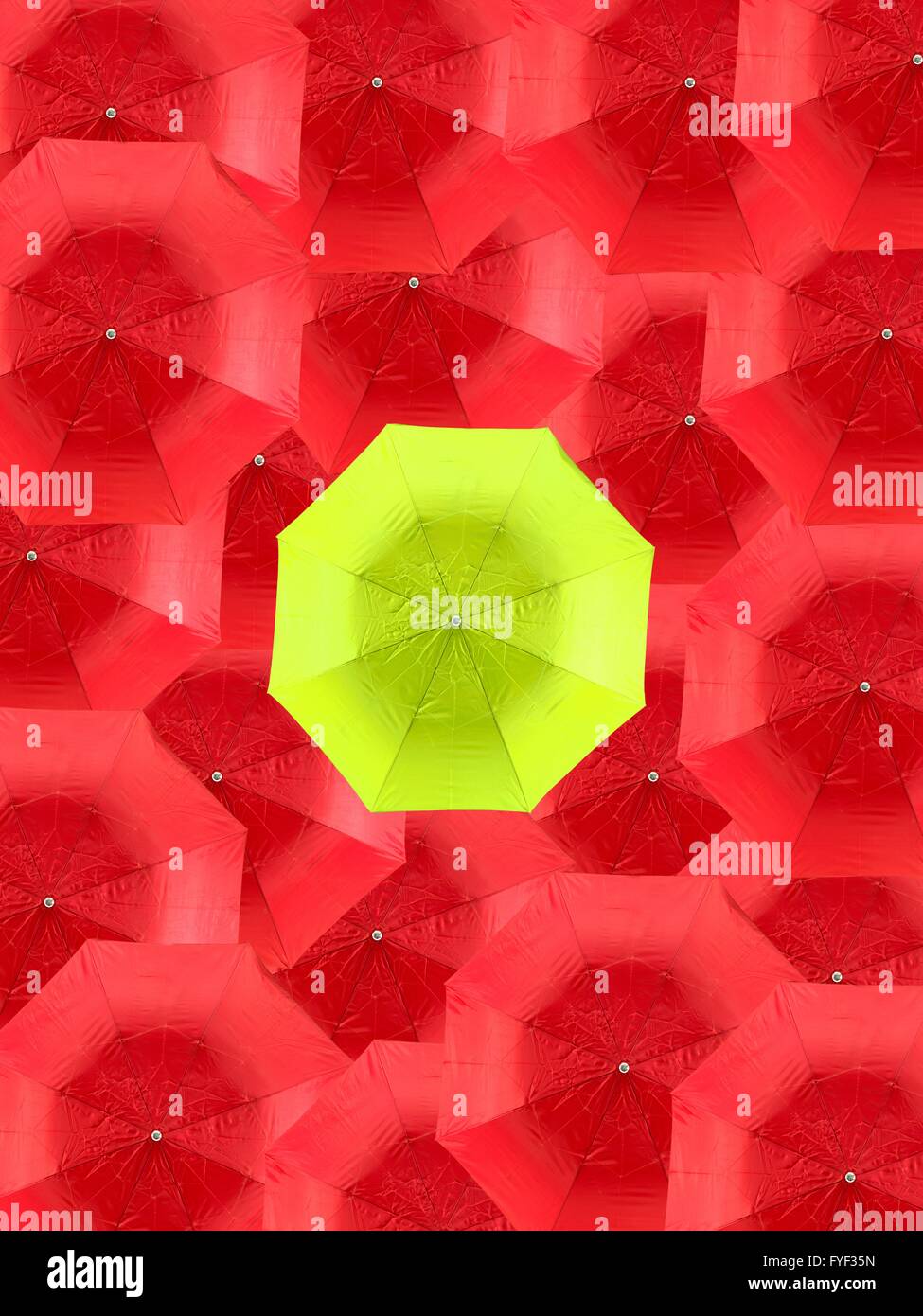 A lime green umbrella isolated against red umbrellas Stock Photo - Alamy