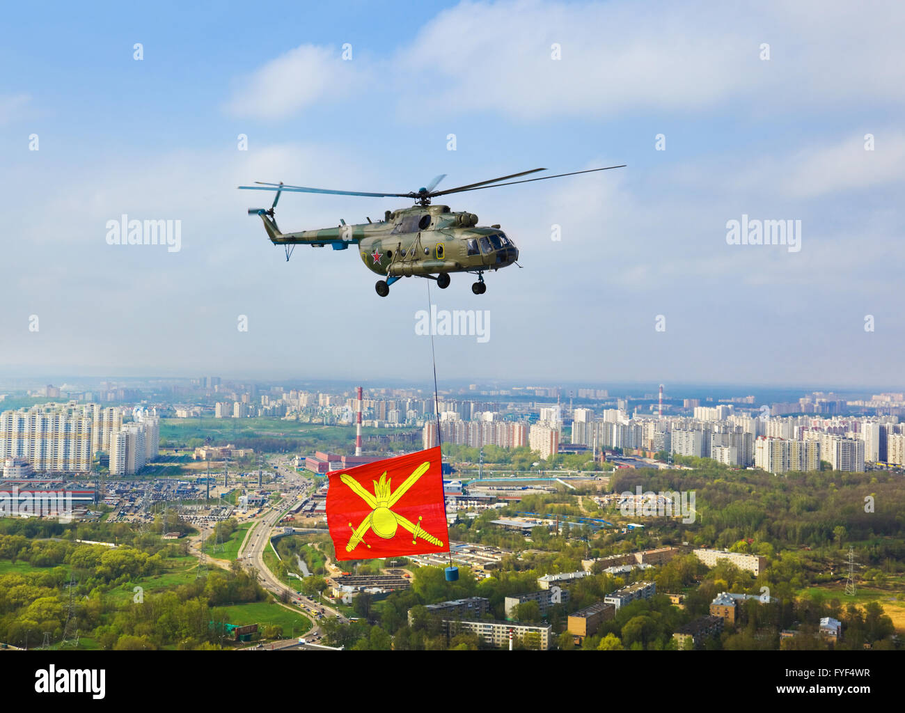 Helicopter with military flag over Moscow at parade of victory day Stock Photo