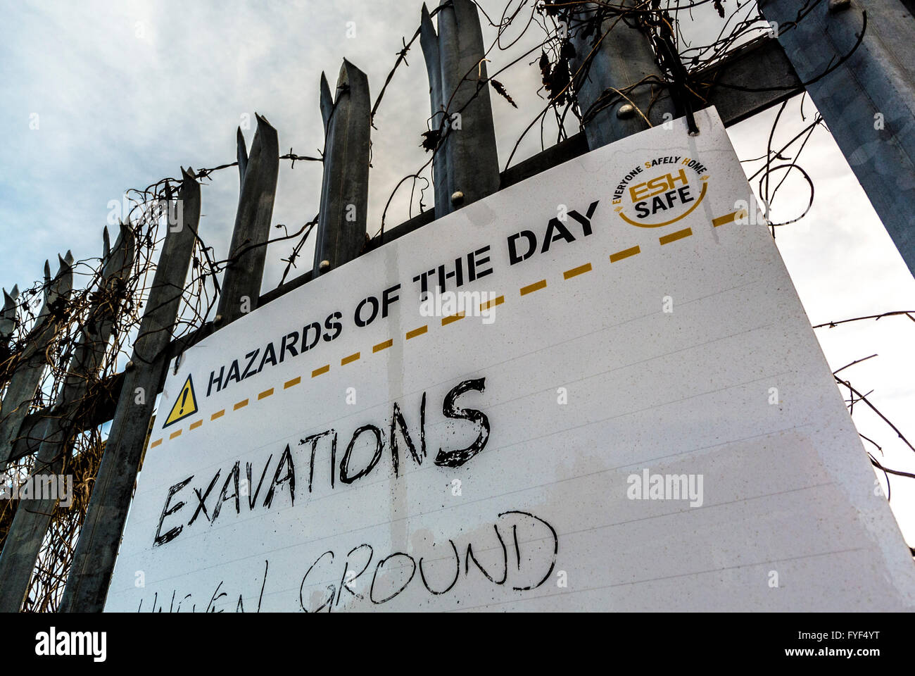 Hazards of the day sign on building site with misspelled word Exavations (Excavations) Stock Photo