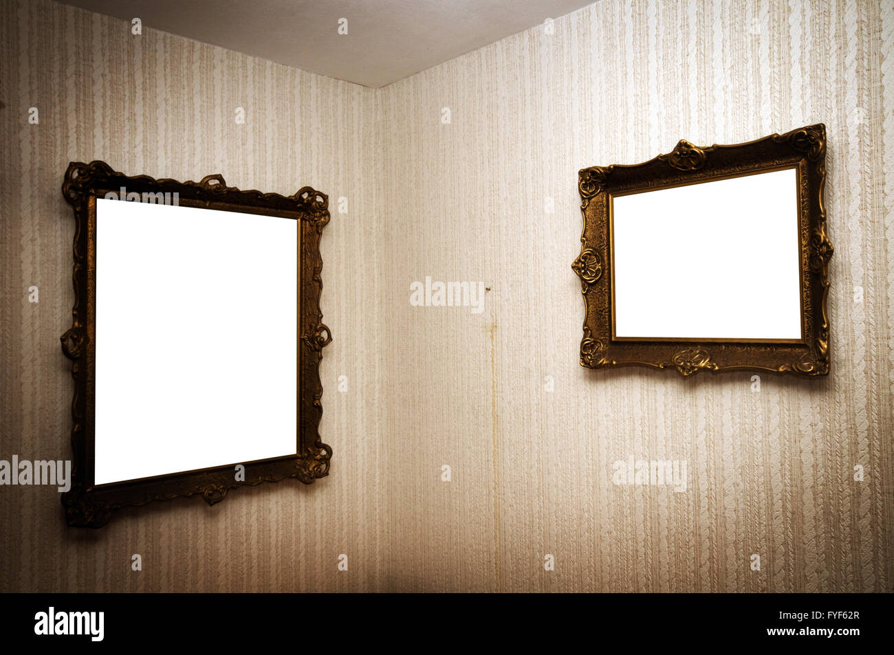 Old ornamented frames on retro grunge wall Stock Photo
