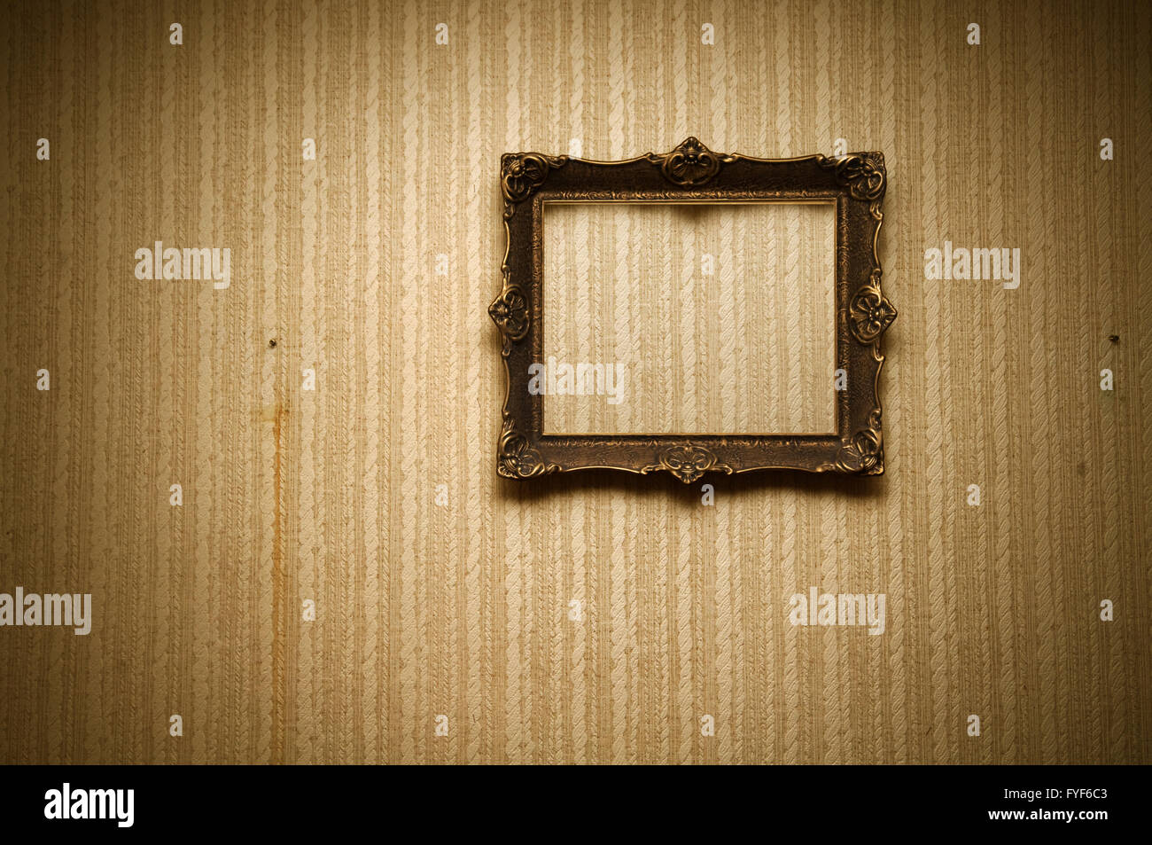 Old ornamented frame on retro grunge wall Stock Photo