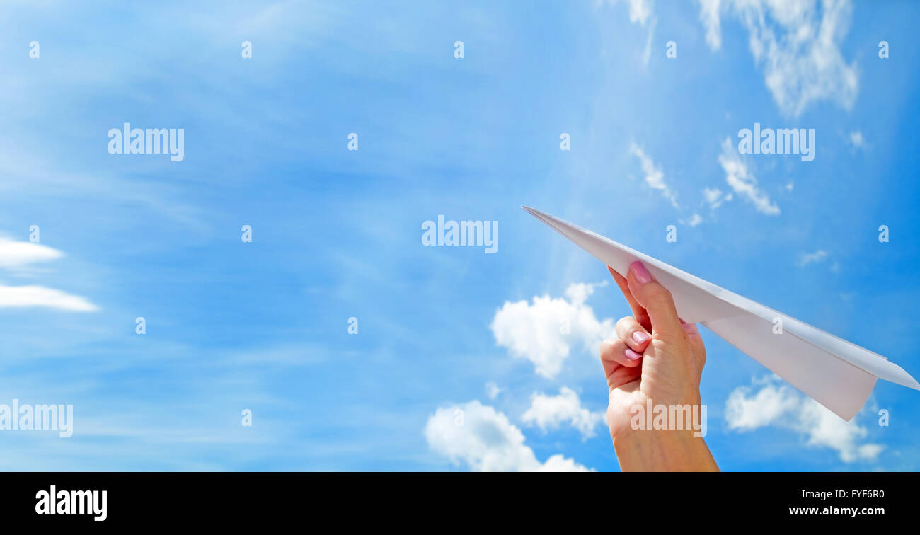 Throwing a paper plane in the sky. Freedom Stock Photo