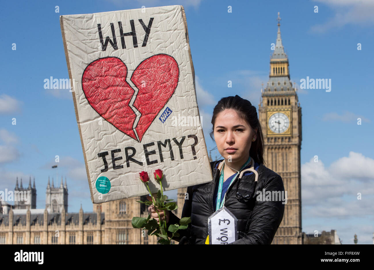 Junior doctors on the picket line outside St Thomas' hospital on Westminster Bridge.A Junior doctor asks Jeremy Hunt 'Why?' Stock Photo