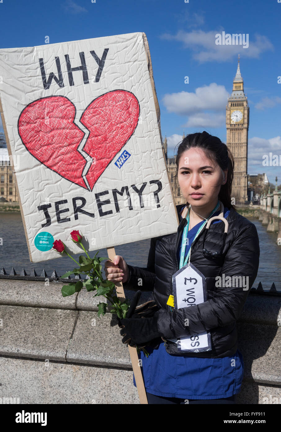 Junior doctors on the picket line outside St Thomas' hospital on Westminster Bridge.A junior doctor asks Jeremy Hunt 'Why?' Stock Photo