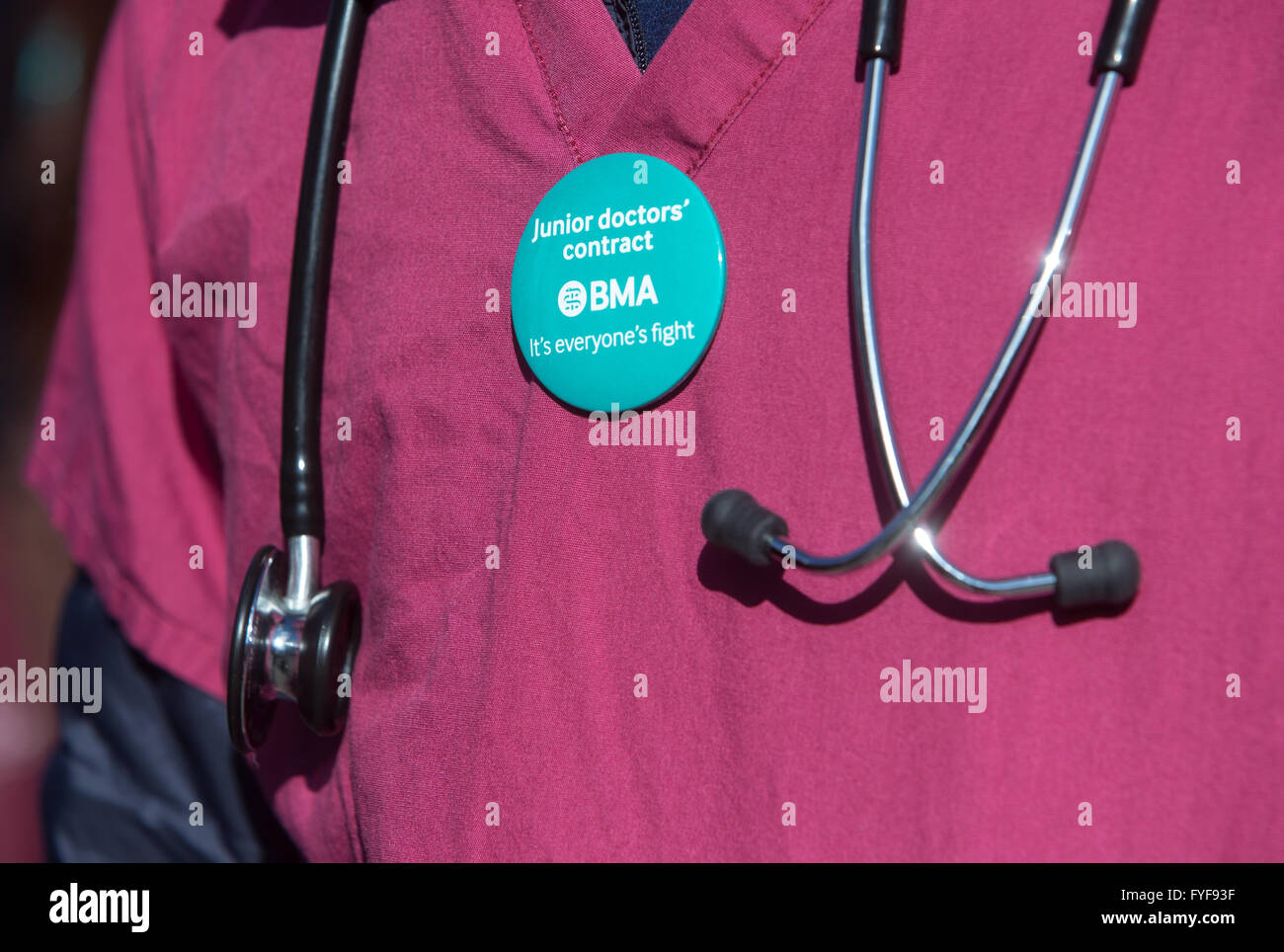 Junior doctors on the picket line outside St Thomas' hospital on Westminster Bridge.Detail of a doctors' scrubs with stethoscope Stock Photo