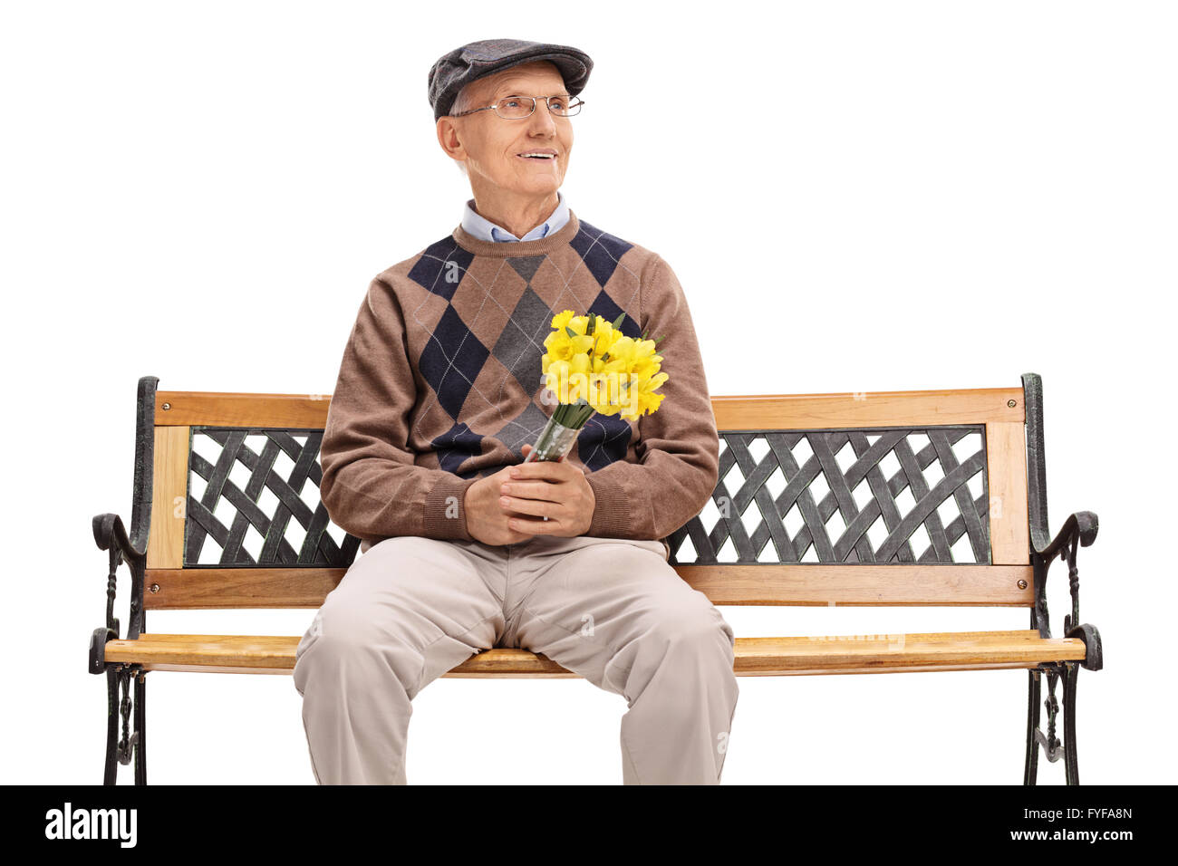 Senior gentleman waiting for his date seated on a bench and holding a bunch of flowers isolated on white background Stock Photo