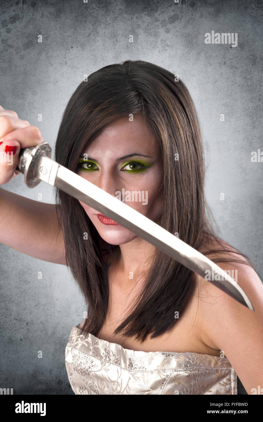 beautiful female warrior holding katana sword Stock Photo