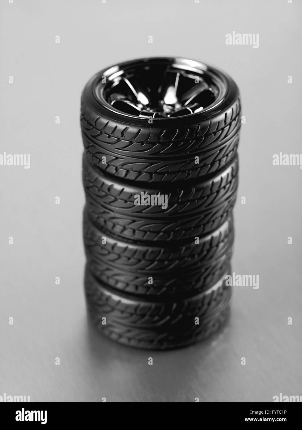 Rubber tyres with sports rims on a silver background Stock Photo