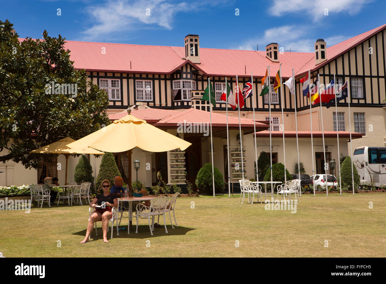 Sri Lanka, Nuwara Eliya, Grand Hotel, guests relaxing in shade on lawn Stock Photo
