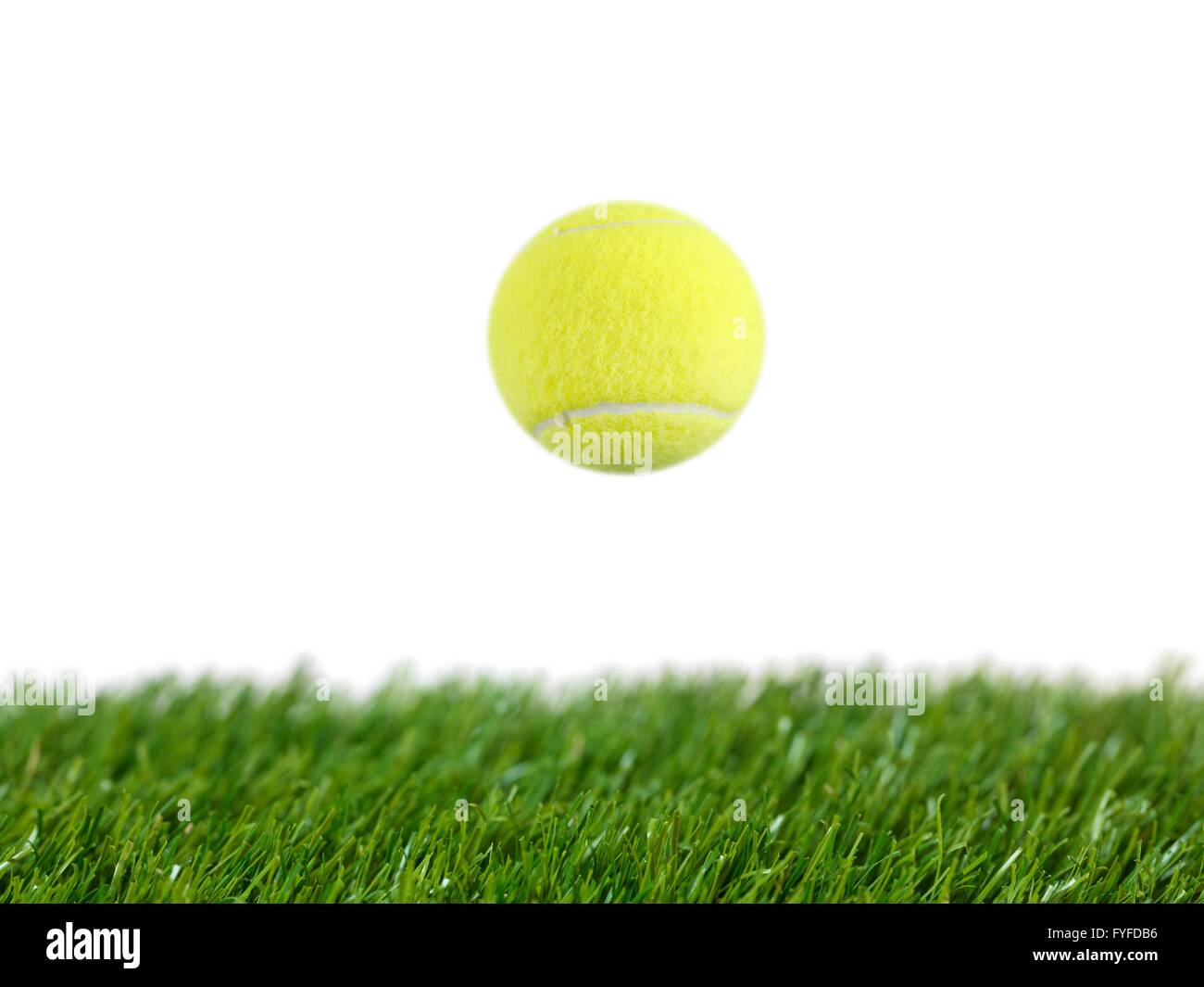 Sporting tennis balls on artificial green grass Stock Photo