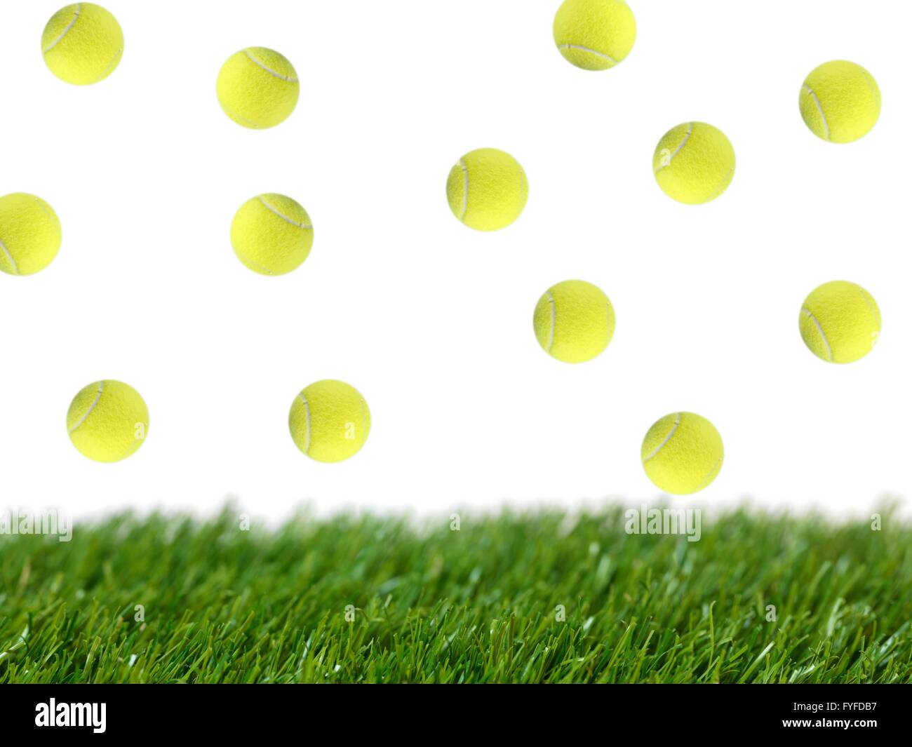Sporting tennis balls on artificial green grass Stock Photo