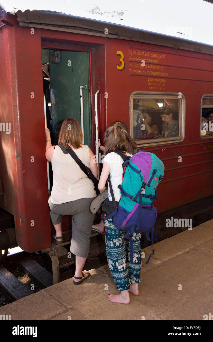 Sri Lanka, Pattipola Railway Station, young female backpackers boarding 3rd class carriage Stock Photo
