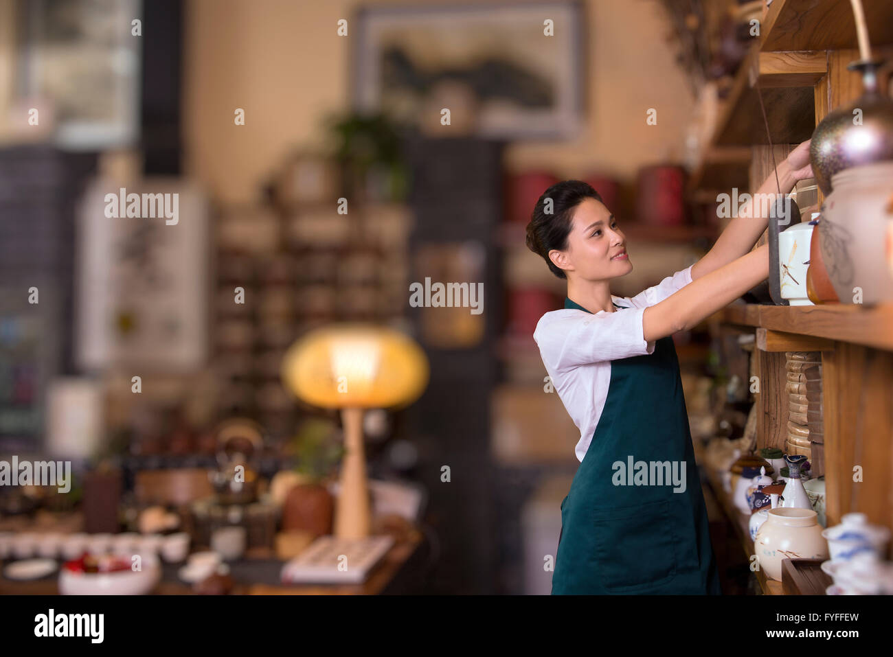 Woman reaching jar on shelf hi-res stock photography and images - Alamy