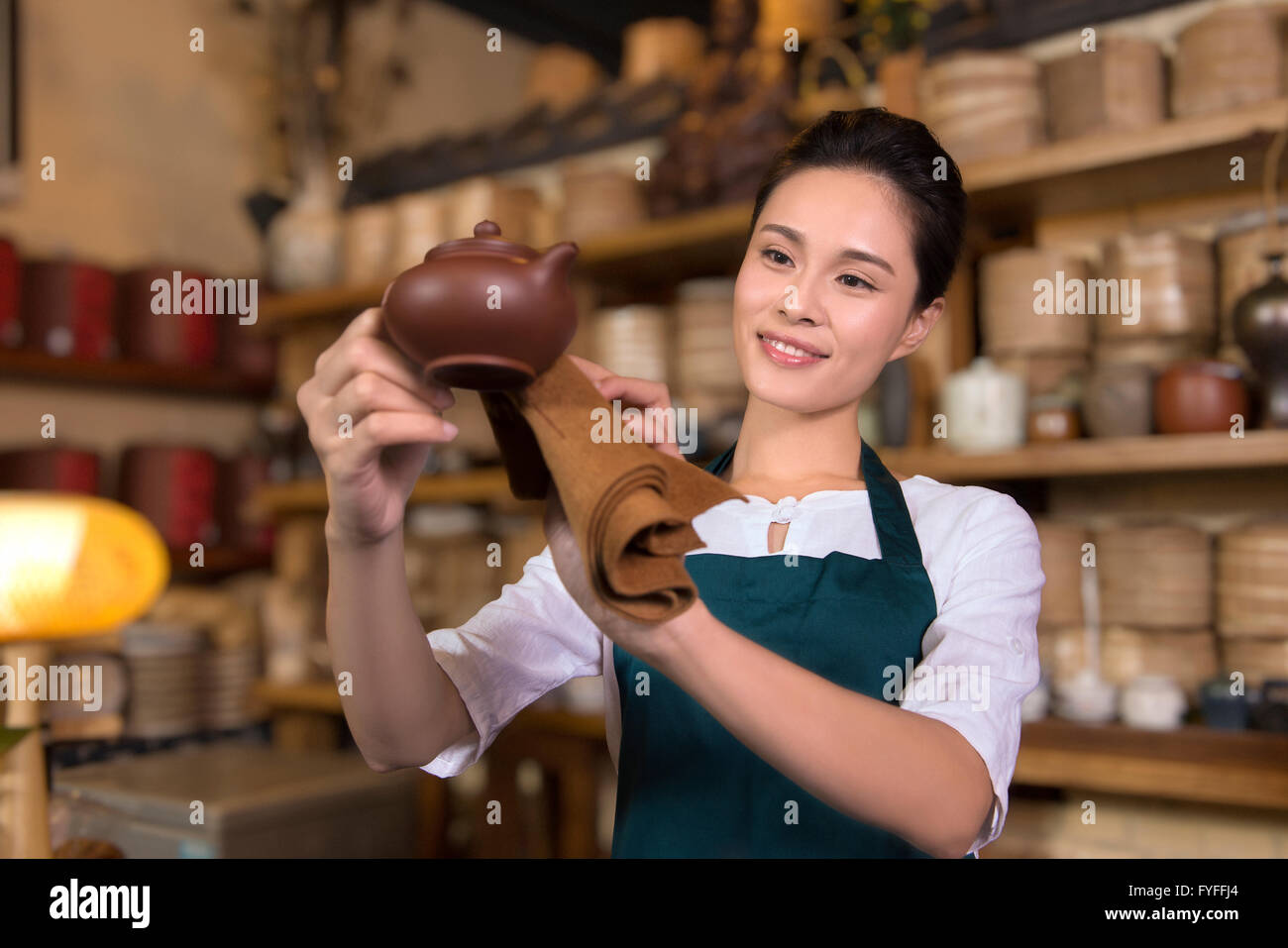 Tea house owner cleaning Stock Photo - Alamy