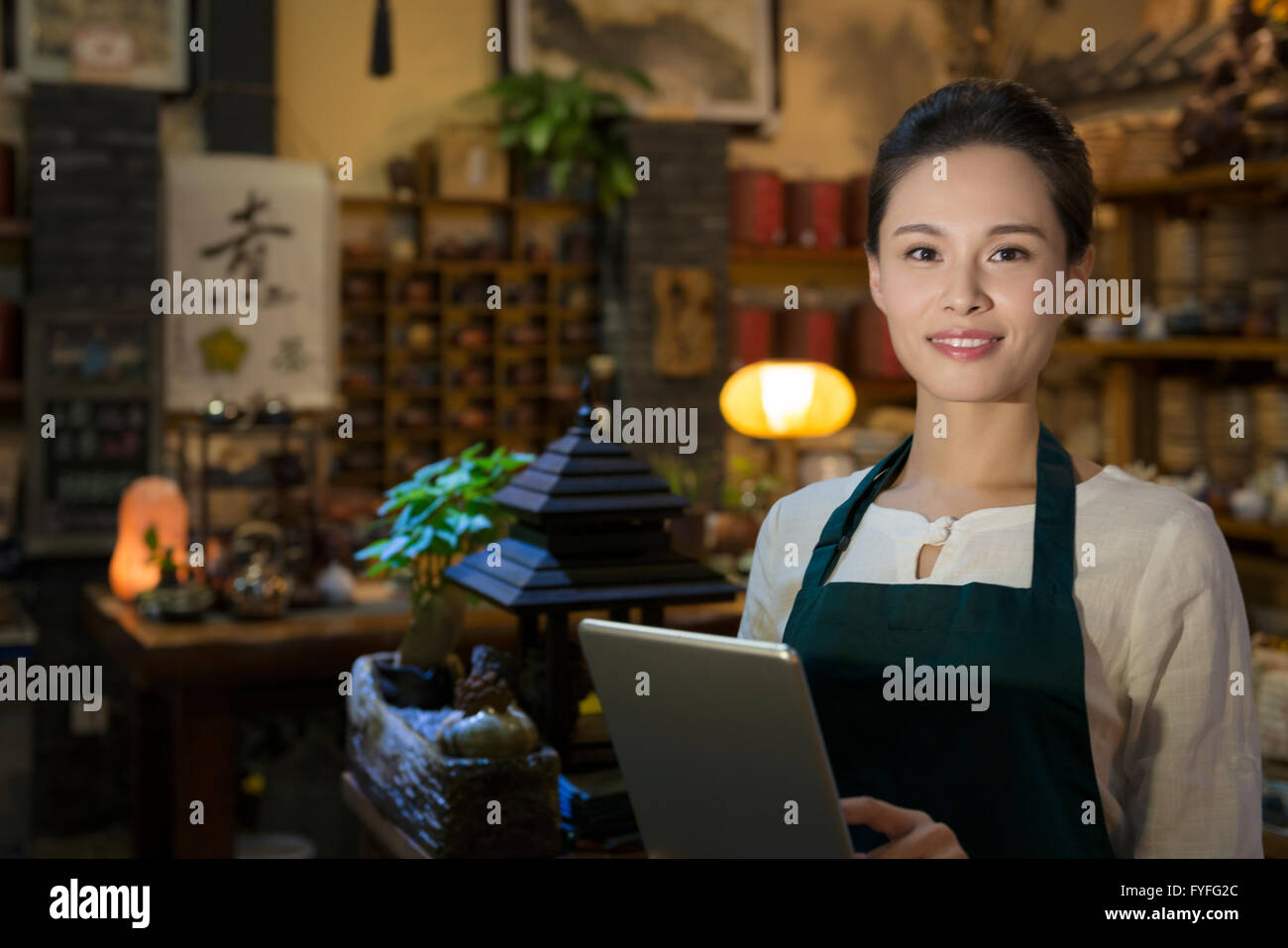 Tea house owner using digital tablet Stock Photo