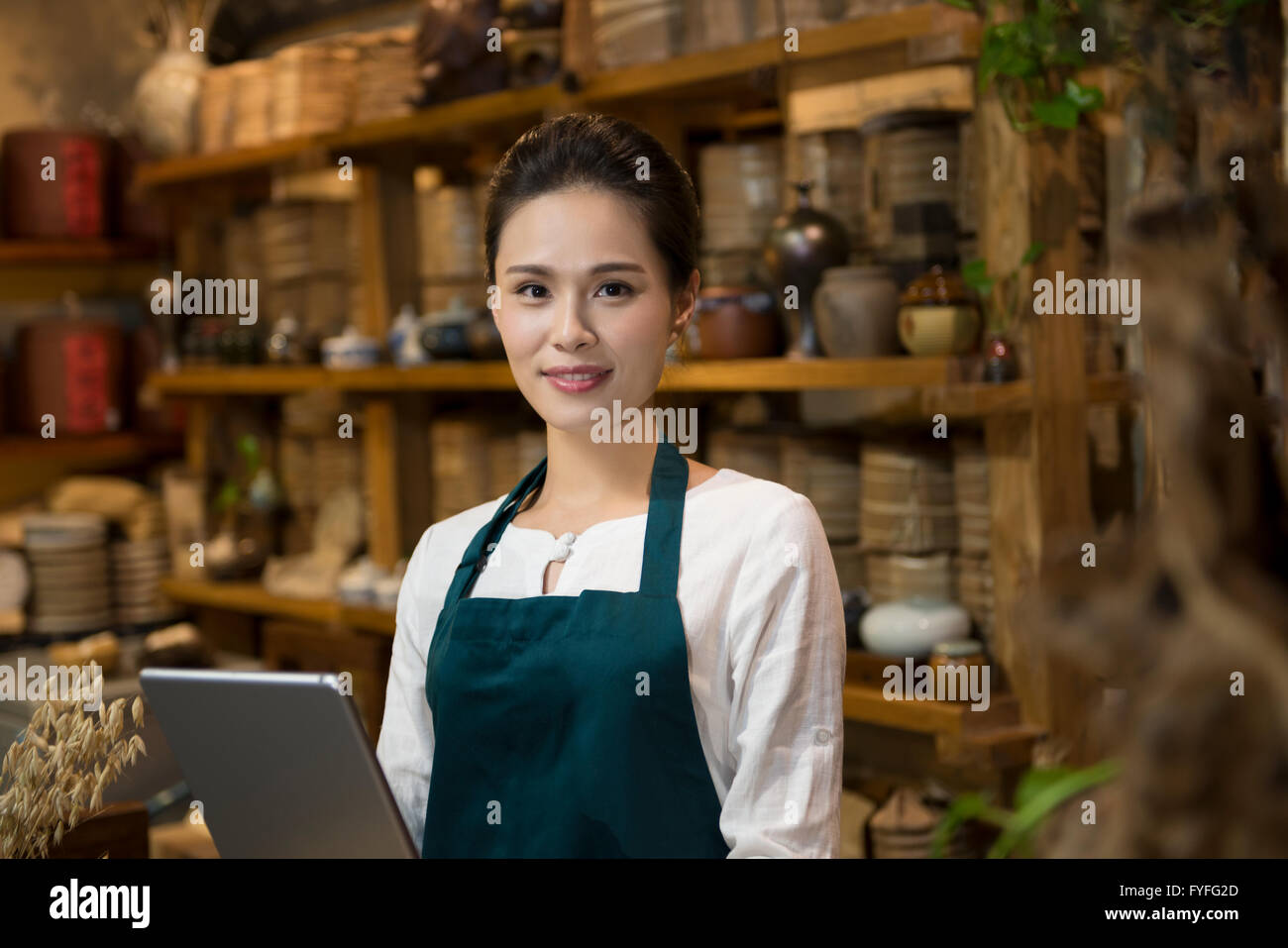 Tea house owner using digital tablet Stock Photo