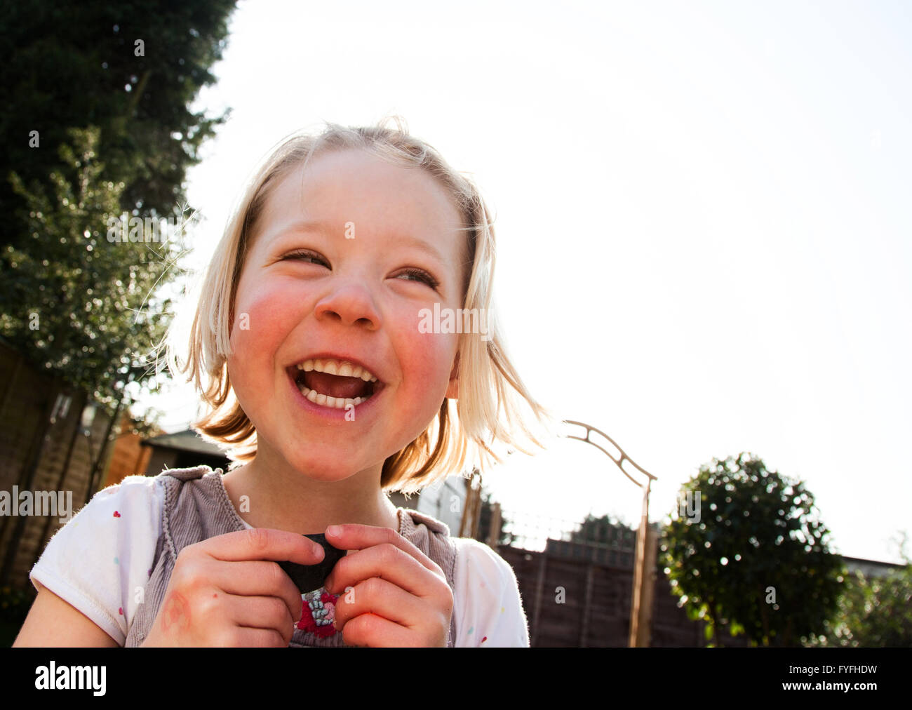 Girl with mad laugh in the garden Stock Photo - Alamy