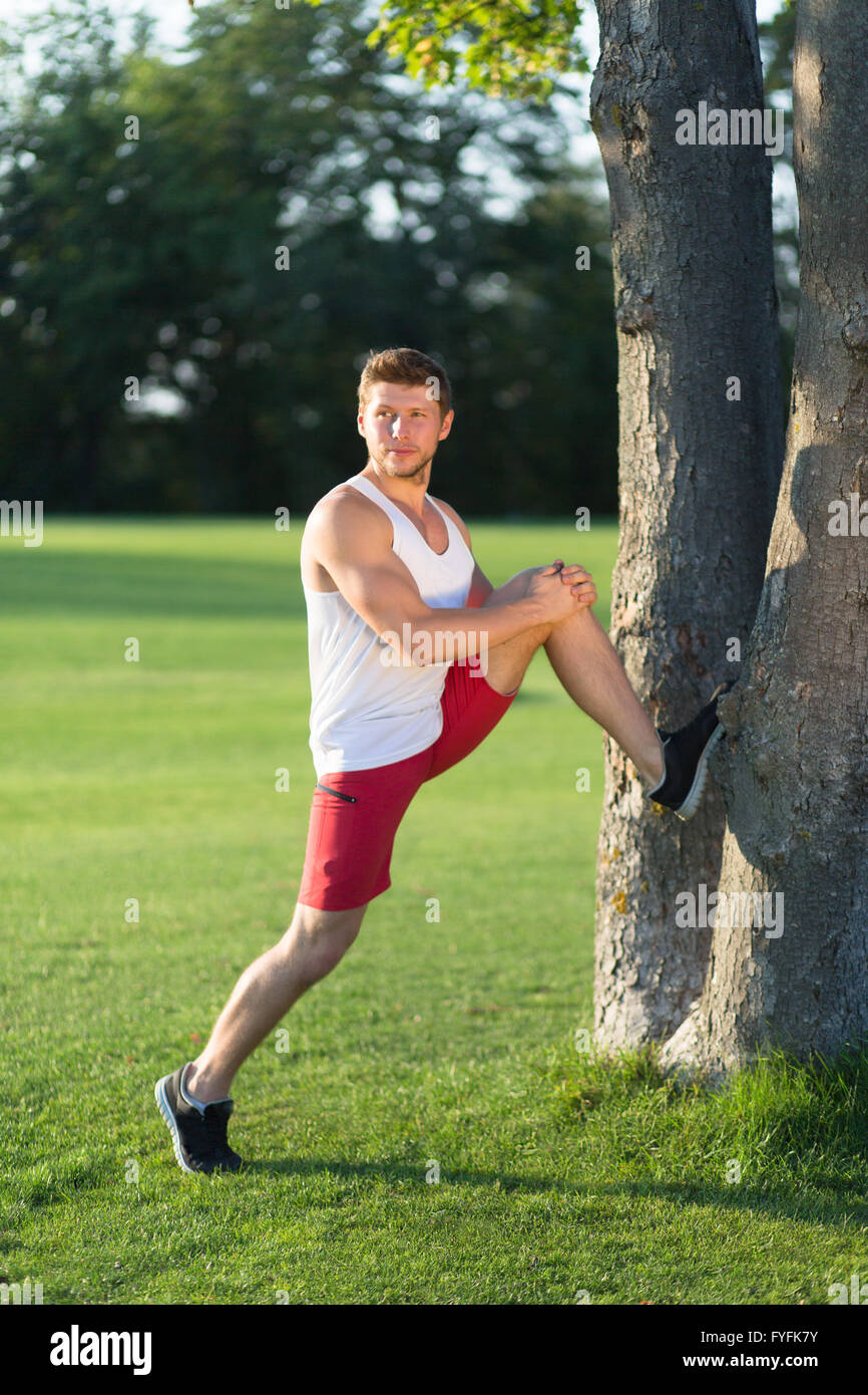 Sportsman stretching outdoors Stock Photo Alamy