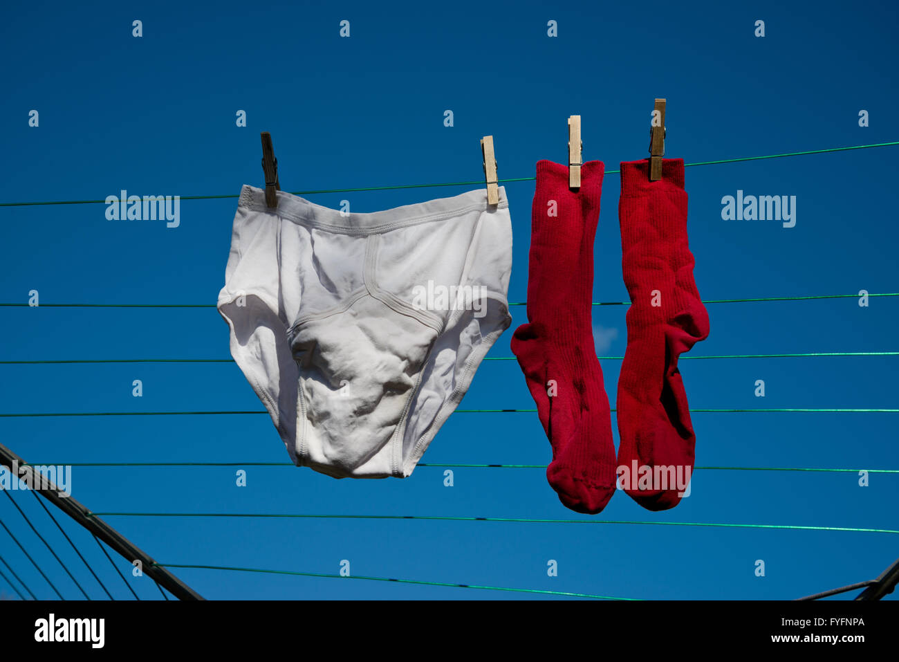 Washed clothes hanging out to dry on a washing line. Male